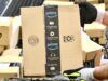 Golfer Battles Back Pain with Prime Day Recommendations Gloved hand gripping a cardboard Amazon Prime box in a warehouse setting.