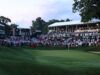 Scratch Golfers vs Tour Pros: The Skill Gap Explained Large crowd of spectators watching a golf tournament from elevated stands along the green fairway.