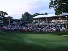 Scratch Golfers vs Tour Pros: The Skill Gap Explained Large crowd of spectators watching a golf tournament from elevated stands along the green fairway.