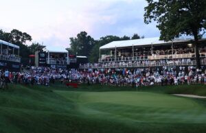 Scratch Golfers vs Tour Pros: The Skill Gap Explained Large crowd of spectators watching a golf tournament from elevated stands along the green fairway.
