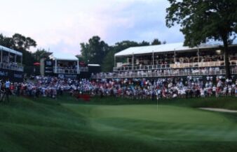 Scratch Golfers vs Tour Pros: The Skill Gap Explained Large crowd of spectators watching a golf tournament from elevated stands along the green fairway.