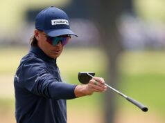 Fowler’s Putter Experiments Continue at John Deere Classic Golfer wearing a navy Cobra cap and mirrored sunglasses, gripping a golf club mid-swing.
